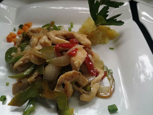 Chicken slices with pepper and onion.